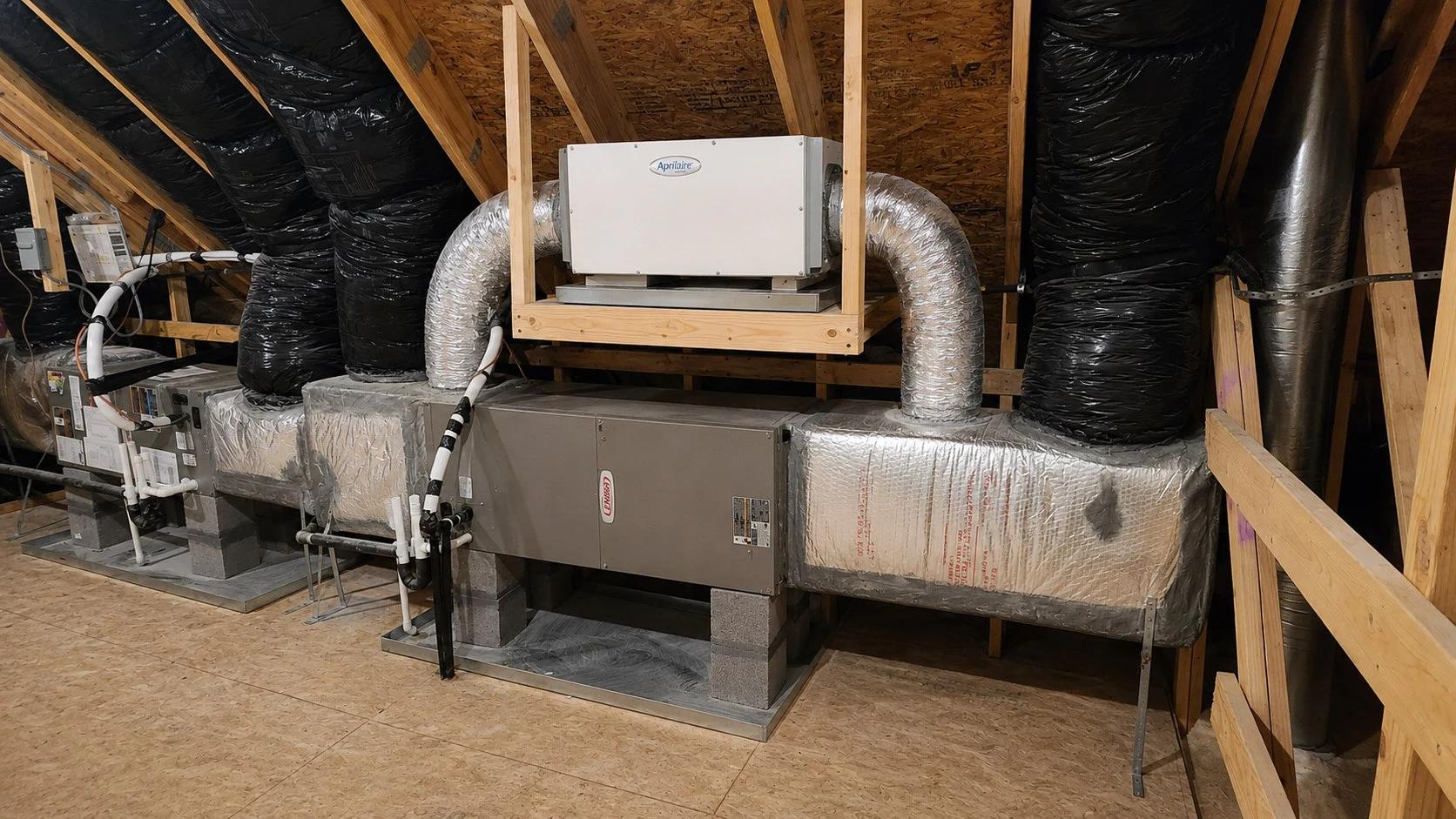 Aprilaire whole-home dehumidifier connected to attic ductwork